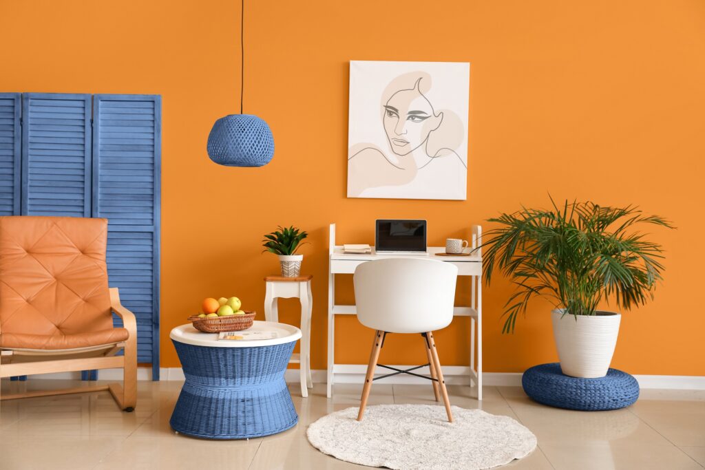 Stylish interior of modern room with workplace and folding scree