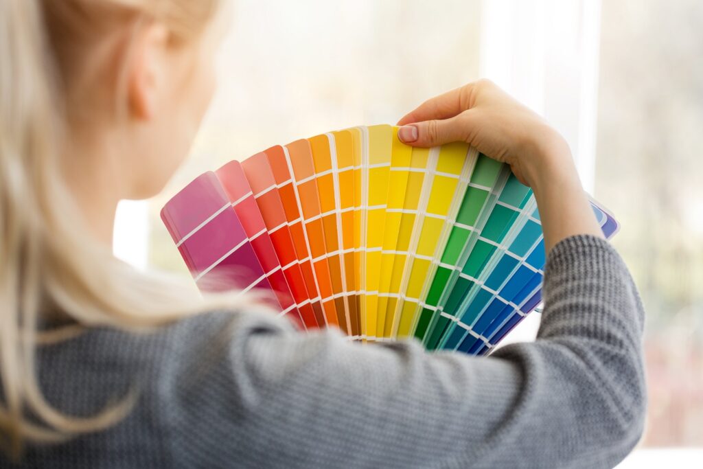 woman designer choosing interior design color from swatch palette